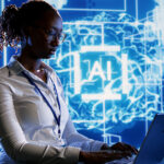 Trained specialist using laptop to maintenance artificial intelligence neural networks made up of interconnected nodes. System administrator using AI system aiding in processing information