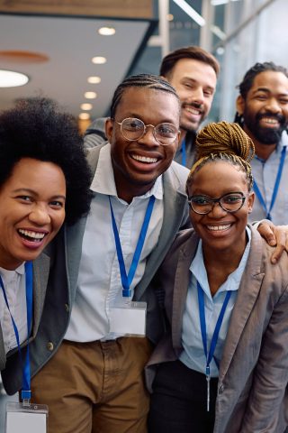 Group of happy business people attending an education event and looking at camera.